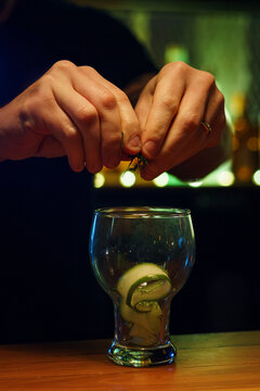 Bartender Prepares Cocktail With Fresh Ingredients in a bar