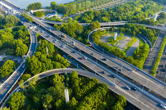 Aerial view of urban highway interchange with traffic - Powered by Adobe