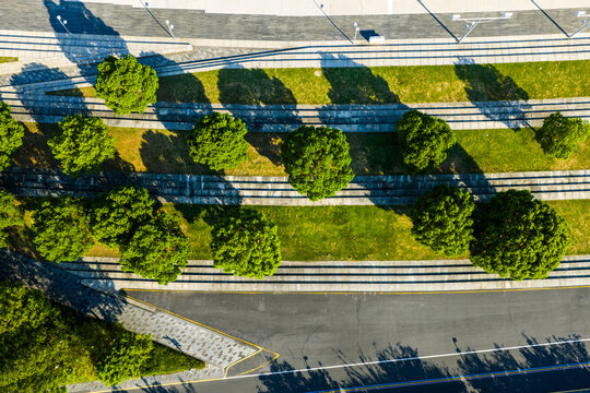 Aerial view of urban green belt with trees and pedestrian walkways