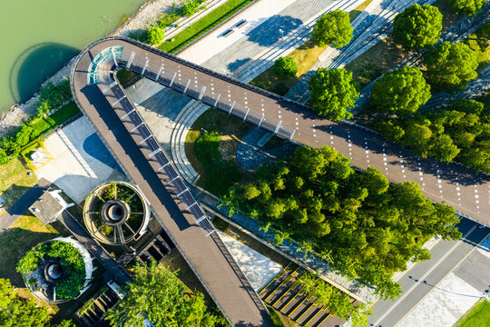 Aerial view of curved walkway and green landscape