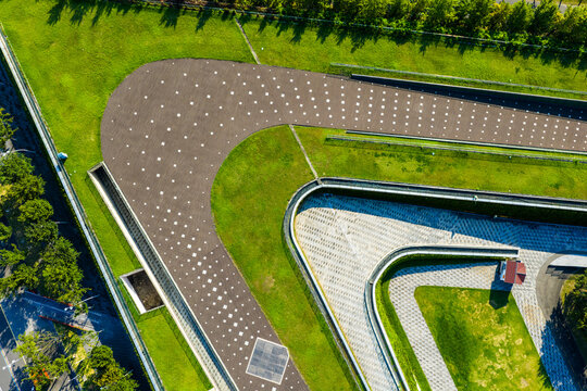 Aerial view of curved walkway and green landscape