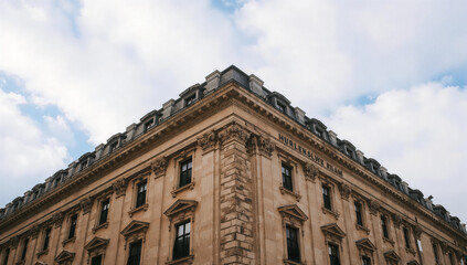 Fototapeta premium Elegant building with multiple windows under a cloudy sky
