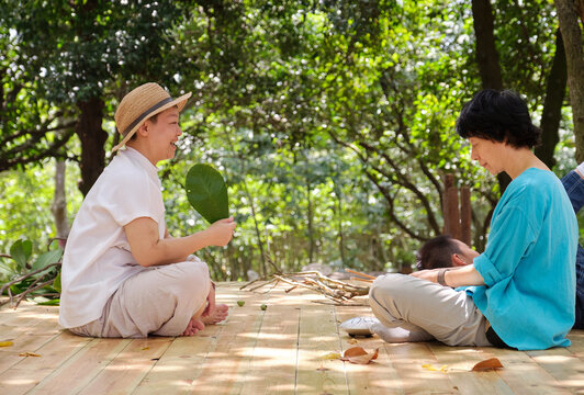 Chinese sisters practicing playing the hollow drum instrument 