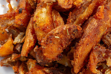 A top down view of a pile of potato wedge, as a background.