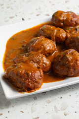 A view of a plate of boneless curry wings.