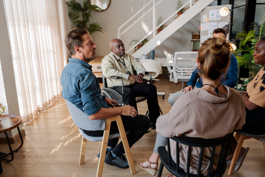 Colleagues sitting for a team building exercise