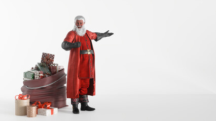 Santa Claus with Gift Bag and Christmas Presents on White Background