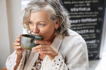 Woman enjoying coffee at a cafÃ©