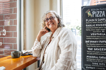Joyful woman enjoying coffee break