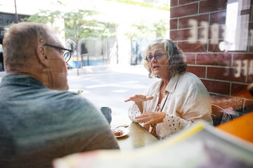 Senior friends talking at a cafe