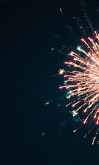 A dark night sky with bright fireworks exploding on one side, leaving clean copy space for text.