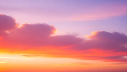 Fototapeta premium Colorful sunset sky background with soft cloud shapes, smooth gradient blend of warm orange, pink, and lavender, abstract nature glow.1