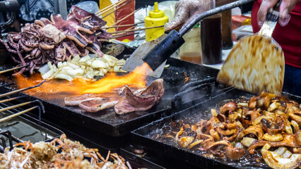 squid cooked by frying and grilling by fire
