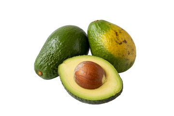 Two whole avocados and one half avocado with pit on black background fruit food