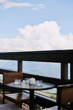 Scenic caf&eacute; table with tea set and mountain view