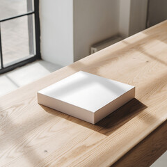 A clean and elegant mockup scene featuring a blank white square book or box resting on a wooden table with natural sunlight and soft shadows from a window