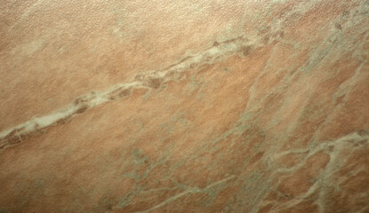 A close-up of pale pink onyx, featuring a pattern with white stripes and polished natural stone inclusions.