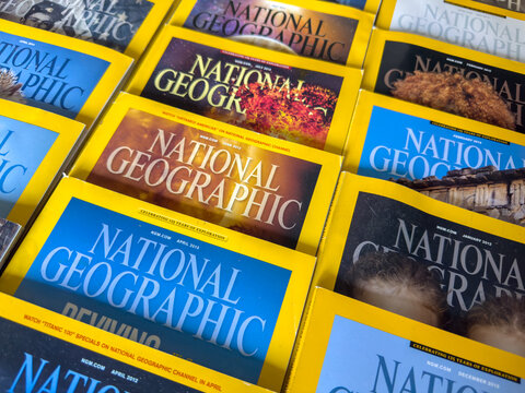 Calgary, Alberta, Canada. Dec 1, 2025. A colorful, detailed view of various National Geographic magazine covers stacked together, featuring the iconic yellow border and different issue dates.