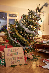 Chaotic Christmas living room with tilted tree & colorful sign. Great for humorous holiday marketing, greeting card concepts, social media posts & lifestyle branding.