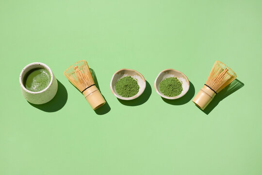 Beautiful matcha tea arrangement with whisks and powder on plate