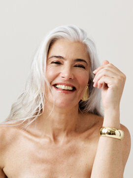 Ageless Beauty With Silver Hair and a Warm Smile in Soft Light