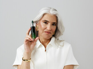 Confident Woman Showcasing Skincare Product in Modern Setting