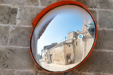 Reflection in a Street Mirror Capturing Gay Couple in Old Town