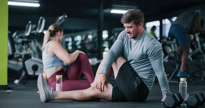 Man, personal trainer and stretching for fitness at gym with exercise, training and flexibility routine. People, coach and warm up to prepare muscles, mobility workout and improve posture of wellness