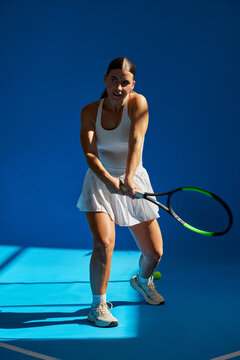 Tennis player prepares to hit during a dynamic indoor match