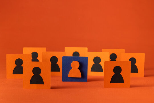 A team of people represented with cutouts, with a leader standing