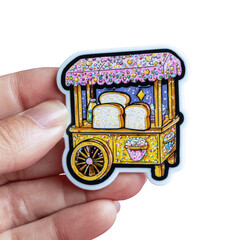 Whimsical bread cart sticker with colorful decorations and slices of bread