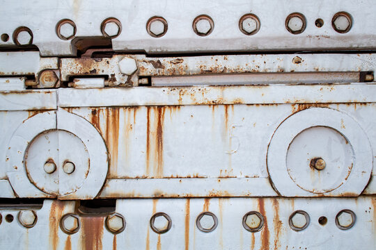 Large machine with rivets and rust spots