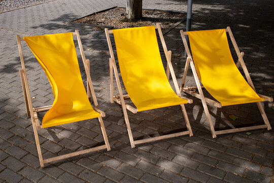 Three folding chairs in the shade