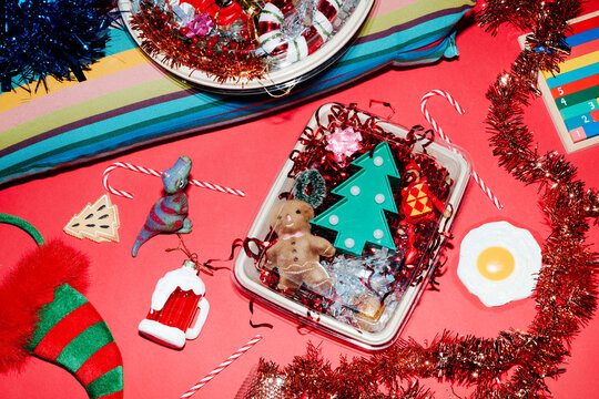 a square box and a round tray filled with christmas toys