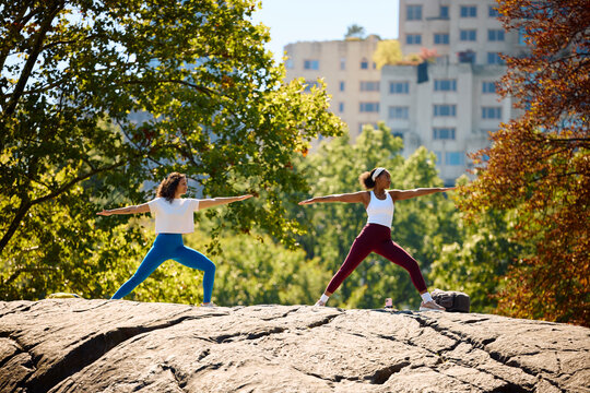 Women practice yoga in the park