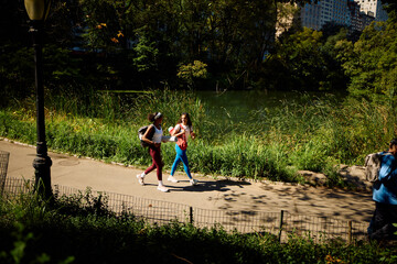 Women go to practice yoga in the park