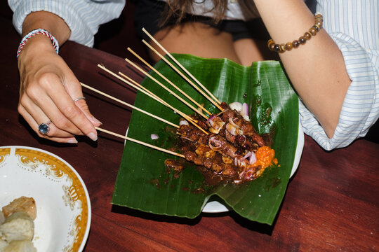 Enjoying Traditional Street Food on a Banana Leaf in the Evening
