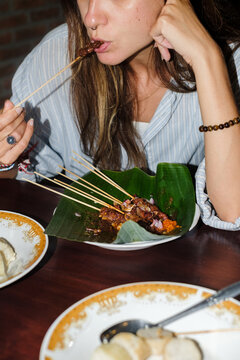 Enjoying Traditional Skewers at a Cozy Dinner Setting