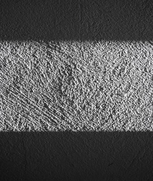 Textured Black and White Wall with Light and Shadow Contrast