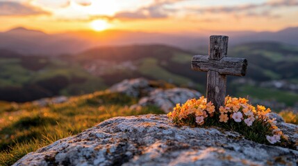 A weathered wooden cross stands atop a rocky mountain peak, adorned with flowers, silhouetted against a vibrant sunset.