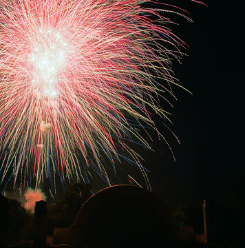 Large red firework burst over night sky  
