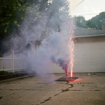 Ground firework with smoke in driveway
