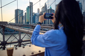 Woman takes photos from Brooklyn bridge