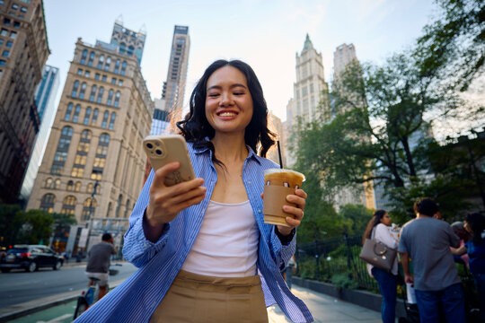 Excited woman walks in New York City