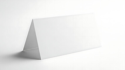 Blank white folded card on a white surface for presentation and design.