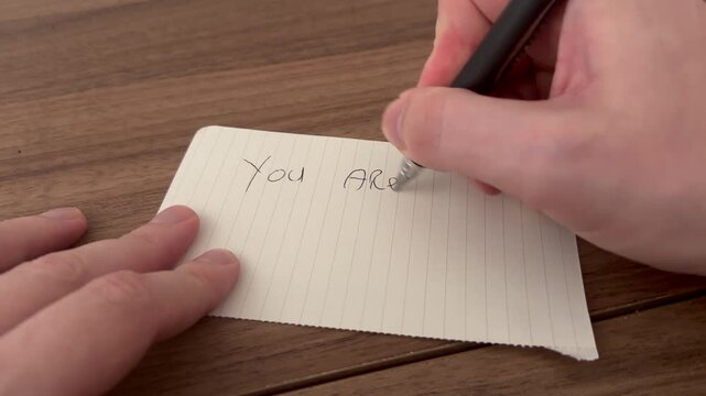 Hand written positive note on a wooden background. Happy Thanksgiving day.	