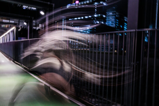 A long exposure runner at night city lights 
