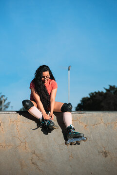 Latina Woman Preparing Rollerblades at Skate Park
