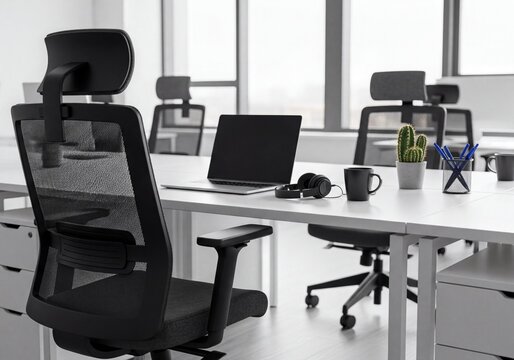 Modern Office Workspace with Empty Desk, Laptop, Ergonomic Chair, and Natural Light