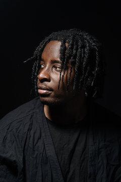 Pensive man with dreadlocks looking to the side